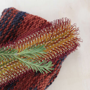Knitted sample in 8ply. Pictured with a banksia flower.