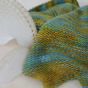 Knitted sample in 8 ply yarn with Nautilus shell.